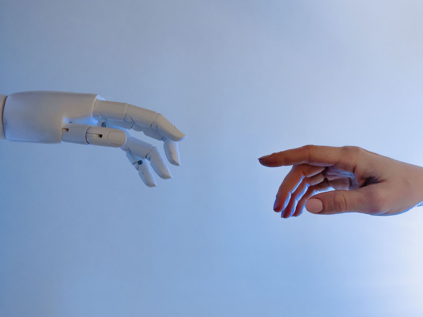 A robotic hand reaching toward a human hand